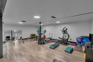 Exercise room featuring wood finished floors and baseboards