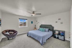 Bedroom featuring light colored carpet and ceiling fan