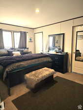 Bedroom with carpet flooring, crown molding, and recessed lighting
