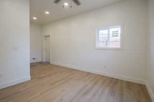 Empty room featuring ceiling fan, light wood-style floors, and recessed lighting