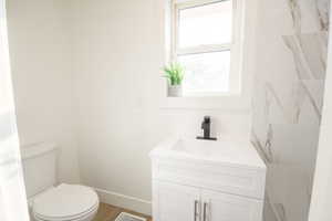 Bathroom featuring vanity and wood finished floors