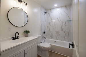 Full bathroom featuring vanity, bathtub / shower combination, and wood finished floors