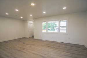 Unfurnished room featuring wood finished floors and recessed lighting