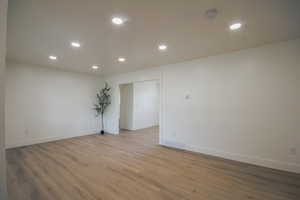 Empty room featuring recessed lighting, light wood-type flooring, and a smoke detector