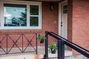 Property entrance featuring brick siding