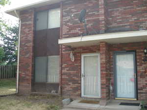 Entrance to property with brick siding