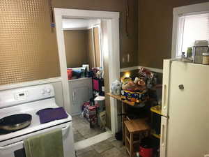 Front House Kitchen  & Laundry room featuring white appliances and tile patterned flooring