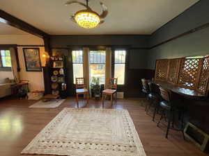 Home office with wood finished floors and a dry bar