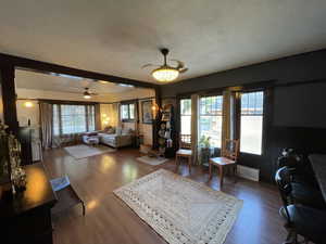 Living room featuring a textured ceiling and wood finished floors
