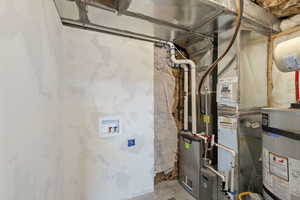 Utility room featuring water heater