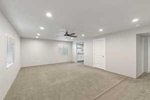 Unfurnished room featuring light colored carpet, ceiling fan, recessed lighting, and a smoke detector