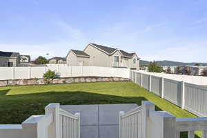 Fenced backyard with a residential view, a patio area, and a mountain view