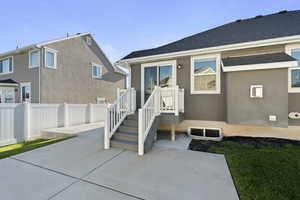 Back of house featuring a patio area and stucco siding