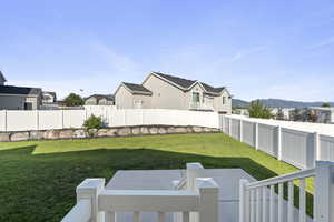 Fenced yard with a residential view and a mountain view