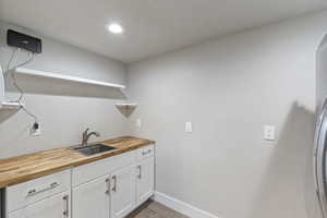 Laundry area with recessed lighting and light wood-style flooring