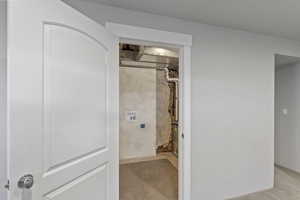 Laundry room featuring light carpet and hookup for a washing machine