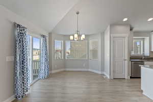 Unfurnished dining area featuring a chandelier, light wood-type flooring, and recessed lighting