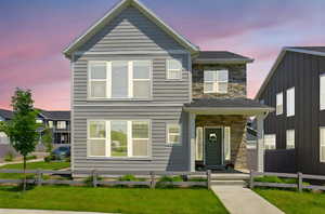 View of front of house featuring stone siding