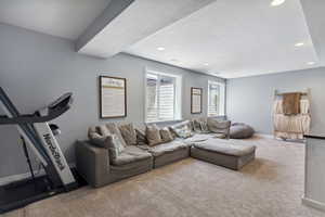Carpeted living room featuring recessed lighting and a textured ceiling