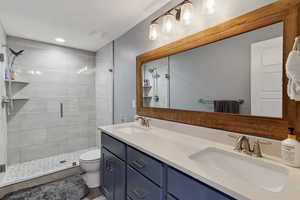Bathroom with a shower stall and double vanity