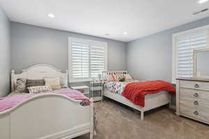 Carpeted bedroom featuring recessed lighting