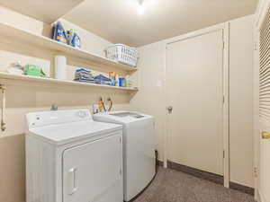 Laundry room featuring separate washer and dryer and baseboards