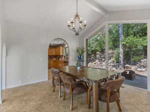 Dining room featuring arched walkways and a chandelier