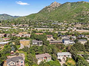 Aerial view of property and surrounding area with a mountainous background
