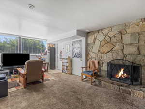 Living area with carpet and a fireplace