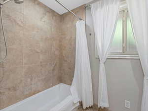 Bathroom with shower / tub combo with curtain