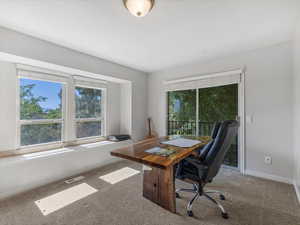 Carpeted office featuring baseboards