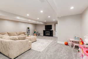 Carpeted living room featuring recessed lighting and a fireplace