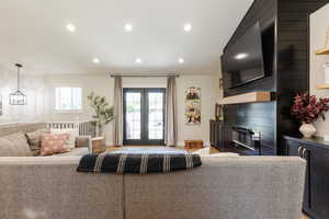 Living area with a glass covered fireplace and recessed lighting