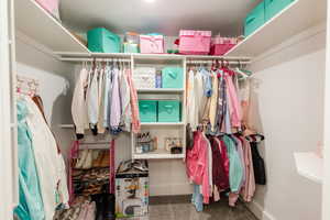 Walk in closet with carpet flooring