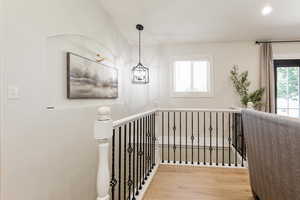 Staircase featuring wood finished floors and recessed lighting