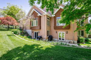 Back of house featuring brick siding