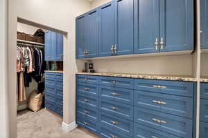 Walk in closet featuring light carpet