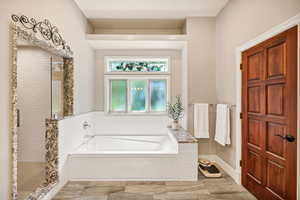 Bathroom with a bath and a shower stall