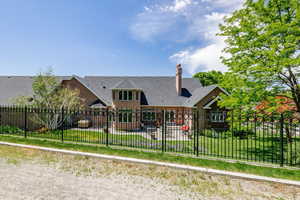 Back of house with a patio and a chimney