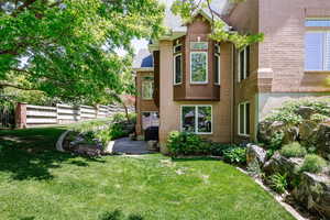 Rear view of house featuring brick siding