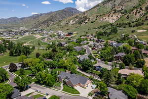 Aerial view of property's location with nearby suburban area and mountains