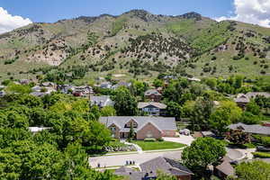Aerial perspective of suburban area featuring a mountain backdrop