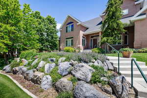 View of front of house with brick siding and a shingled roof