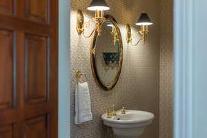 Bathroom featuring a sink and a chandelier