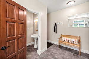 Bathroom featuring marble finish flooring and baseboards
