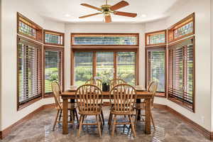 Dining area featuring marble tiled floors, healthy amount of natural light, a ceiling fan, and recessed lighting