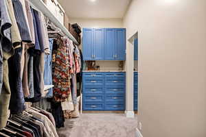 Spacious closet with light colored carpet