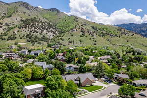 Aerial perspective of suburban area featuring a mountainous background