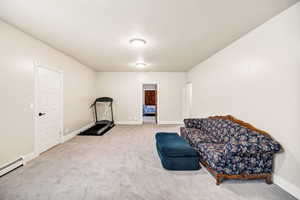 Sitting room featuring a baseboard radiator and carpet flooring
