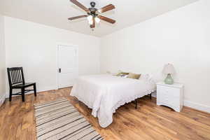 Bedroom with light wood finished floors and ceiling fan
